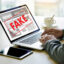 fake news - man reading fake news on laptop