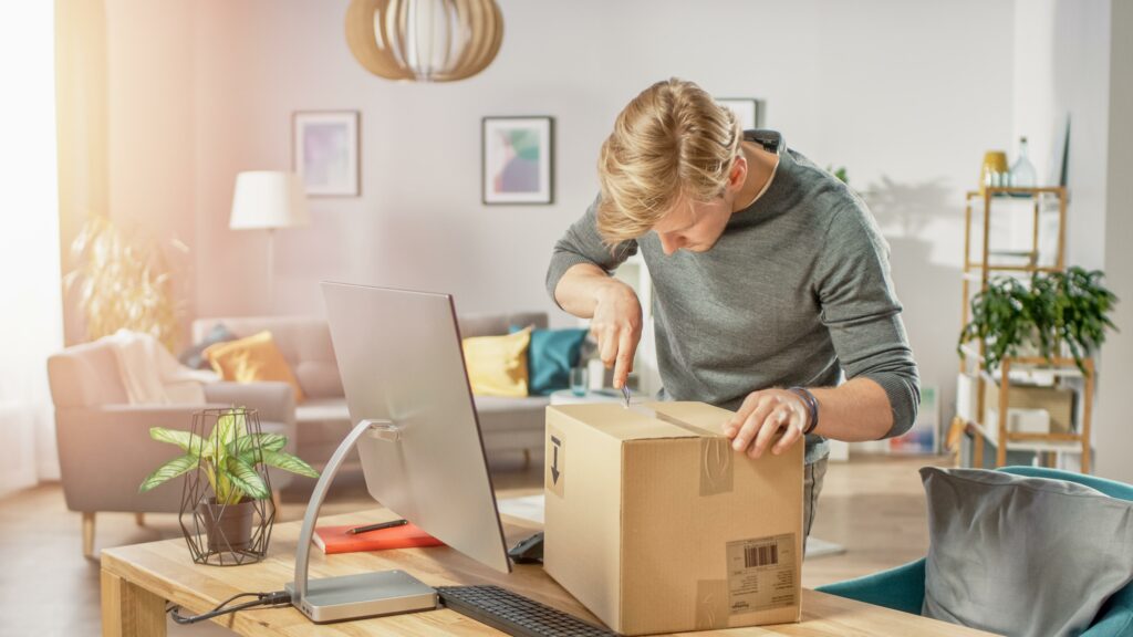 man packing box living room